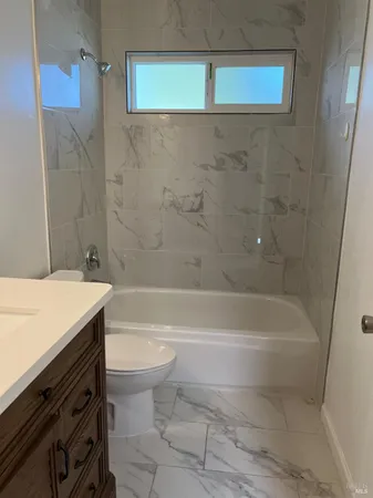 a bathroom with a bathtub and a toilet