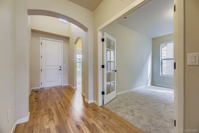 a view of hallway with wooden floor