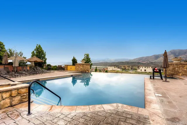 a view of swimming pool with outdoor seating and lake view