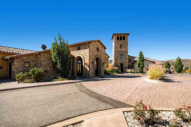 a view of a street with wooden fence