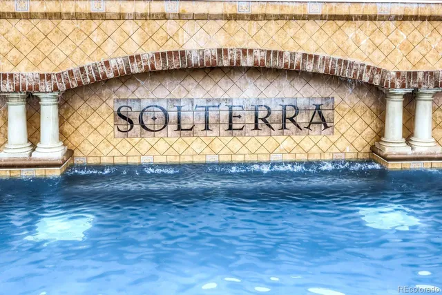 a front view of a house with a garden and yard