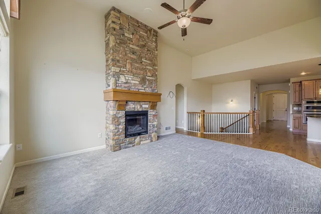 an empty room with furniture and a fireplace