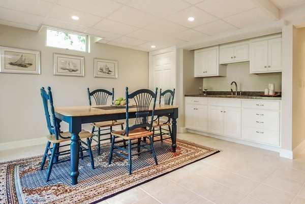 55 Captain Carltons Road Barnstable, MA 02635 - Photo 16 of 24 a kitchen with stainless steel appliances granite countertop a table and chairs in it