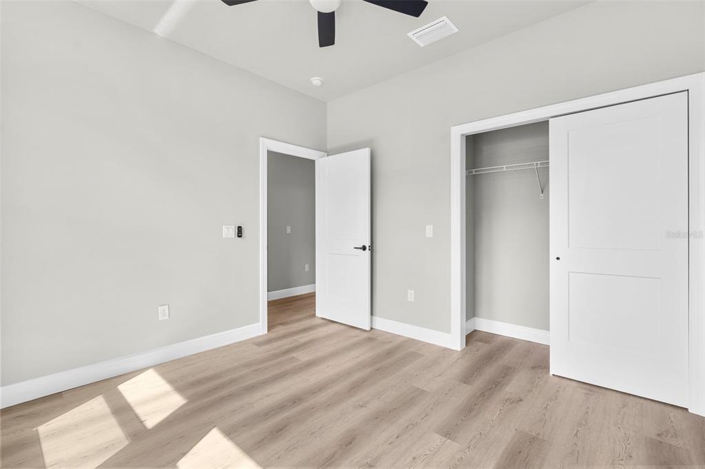 3 Lupine Street Homosassa, FL 34446 - Photo 11 of 44 an empty room with wooden floor cabinet and windows