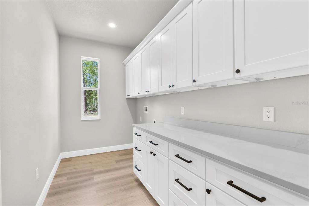 3 Lupine Street Homosassa, FL 34446 - Photo 15 of 44 a kitchen with white cabinets and a window