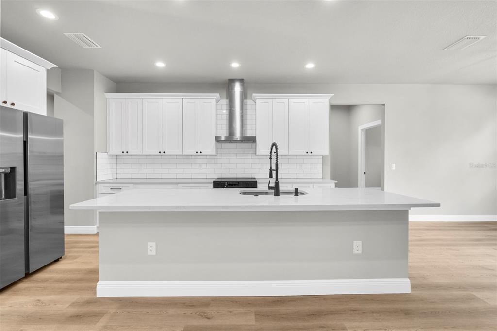 3 Lupine Street Homosassa, FL 34446 - Photo 2 of 44 a kitchen with stainless steel appliances granite countertop a sink a refrigerator and white cabinets