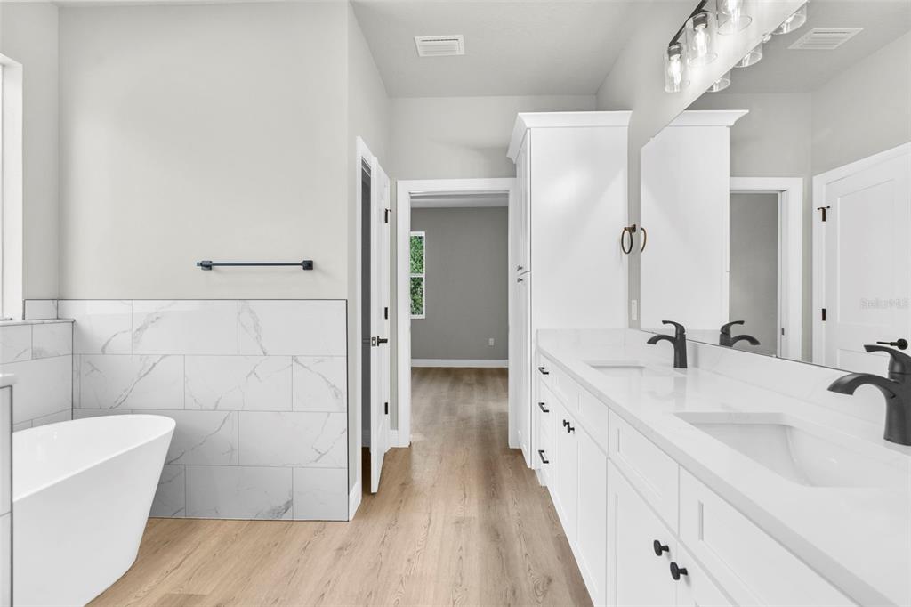 3 Lupine Street Homosassa, FL 34446 - Photo 26 of 44 a en suite bathroom with a double vanity sink a mirror and a bathtub