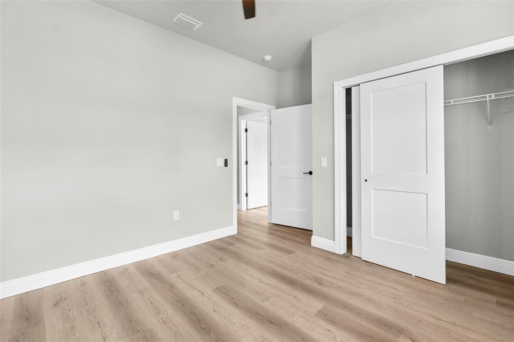 3 Lupine Street Homosassa, FL 34446 - Photo 28 of 44 a view of an empty room with wooden floor