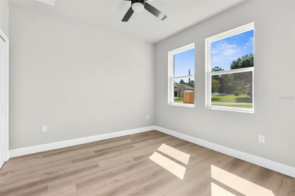 3 Lupine Street Homosassa, FL 34446 - Photo 29 of 44 a view of an empty room with a window and wooden floor