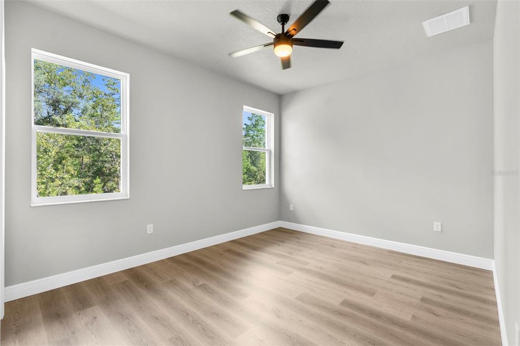 3 Lupine Street Homosassa, FL 34446 - Photo 30 of 44 a view of empty room with wooden floor and fan
