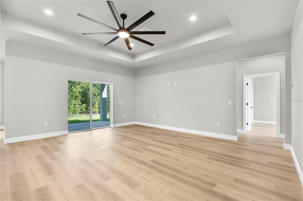 3 Lupine Street Homosassa, FL 34446 - Photo 32 of 44 an empty room with wooden floor and windows