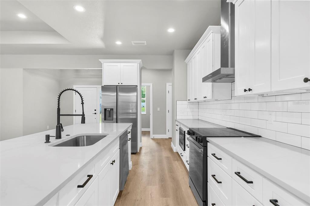 3 Lupine Street Homosassa, FL 34446 - Photo 7 of 44 a kitchen with a sink cabinets and stainless steel appliances