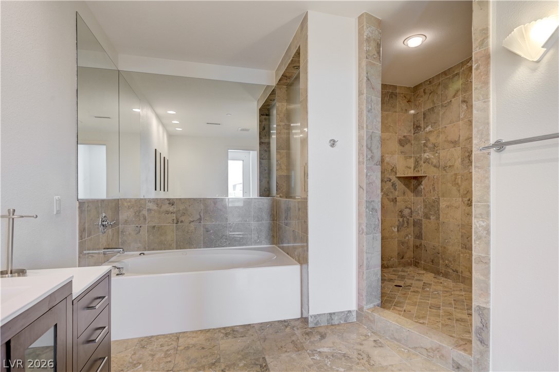 360 East Desert Inn Road, Unit 402 Las Vegas, NV 89109 - Photo 21 of 40 Indulge in this bathroom featuring a soaking tub and a spacious walk-in shower.