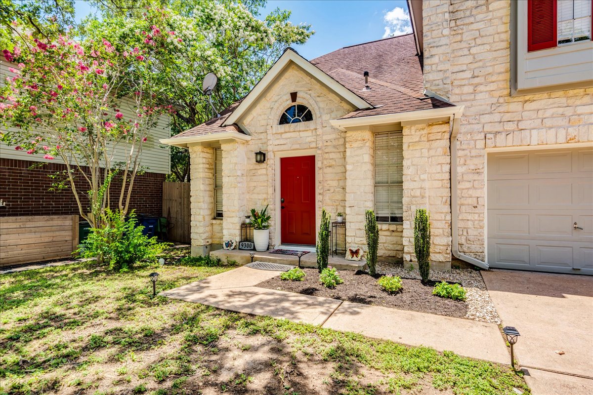 9300 Tea Rose Trail Austin, TX 78748 - Photo 6 of 33 A charming stone facade with a vibrant red door welcomes you to this delightful home.