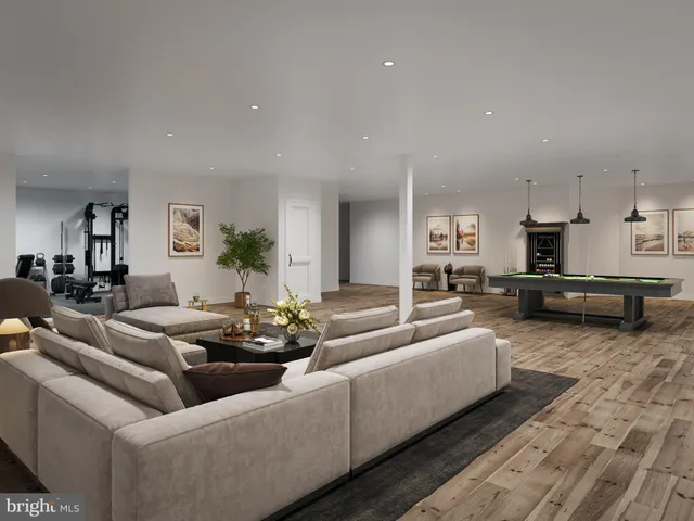 a living room with furniture white kitchen and a couch