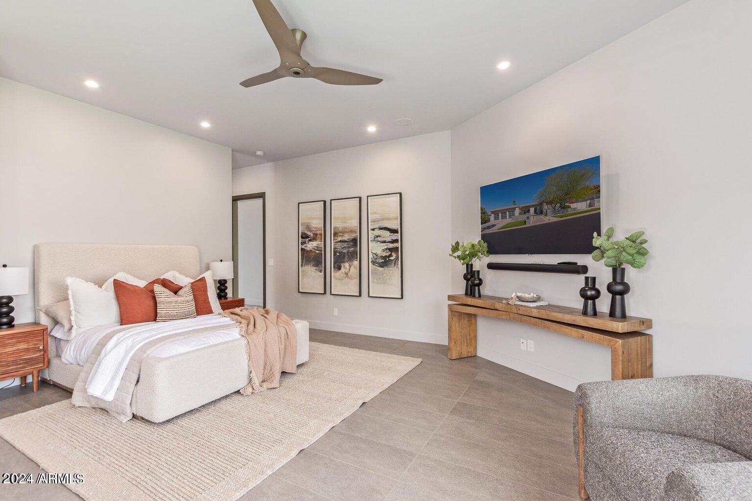 5833 North 46th Street Phoenix, AZ 85018 - Photo 14 of 29 a bedroom with a large bed and a flat screen tv