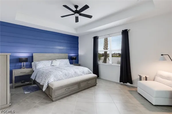 a spacious bedroom with a bed and a ceiling fan