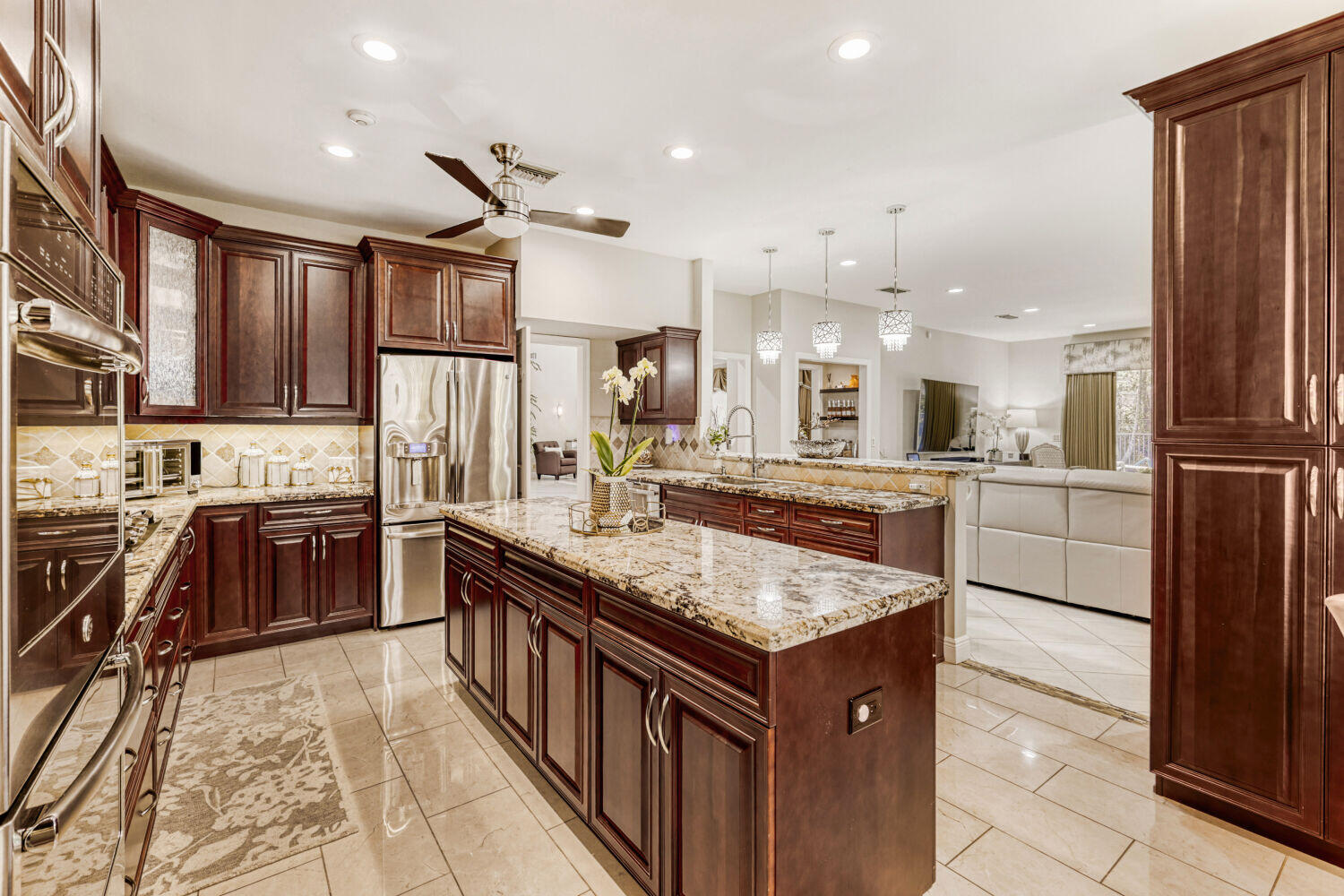 10273 St Andrews Road Boynton Beach, FL 33436 - Photo 12 of 28 a kitchen with kitchen island granite countertop lots of counter top space and stainless steel appliances