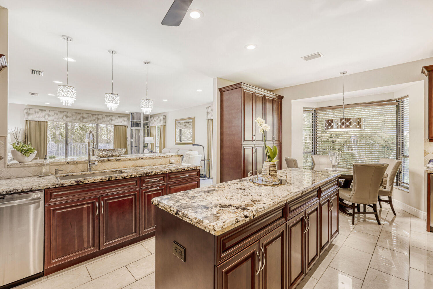 10273 St Andrews Road Boynton Beach, FL 33436 - Photo 13 of 28 a kitchen with granite countertop sink stove and dining table