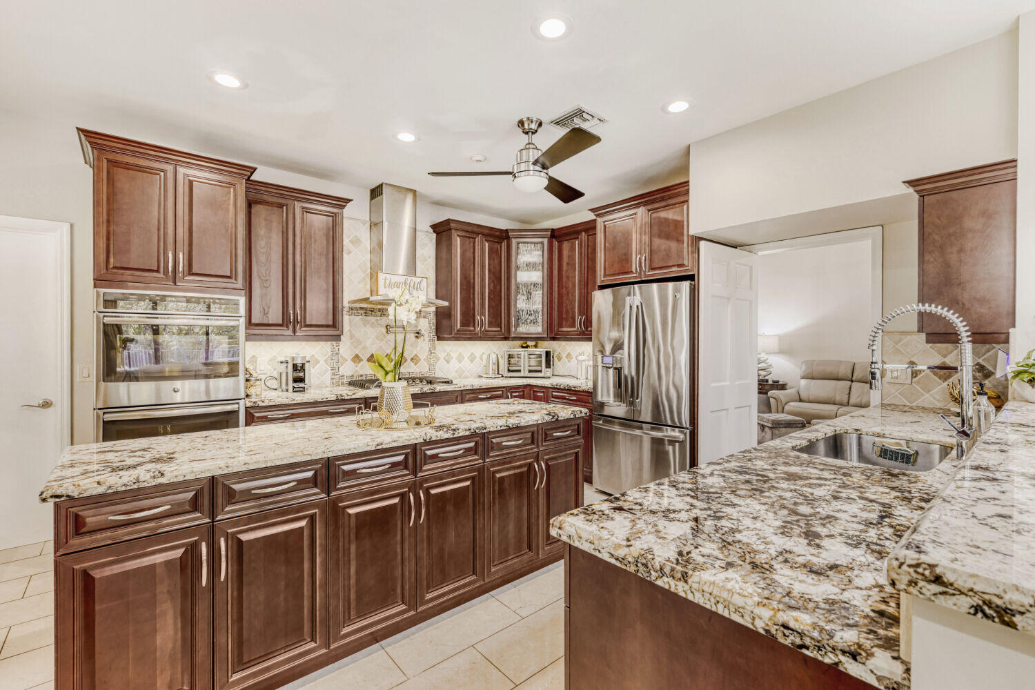 10273 St Andrews Road Boynton Beach, FL 33436 - Photo 14 of 28 a kitchen with stainless steel appliances granite countertop a sink stove and refrigerator