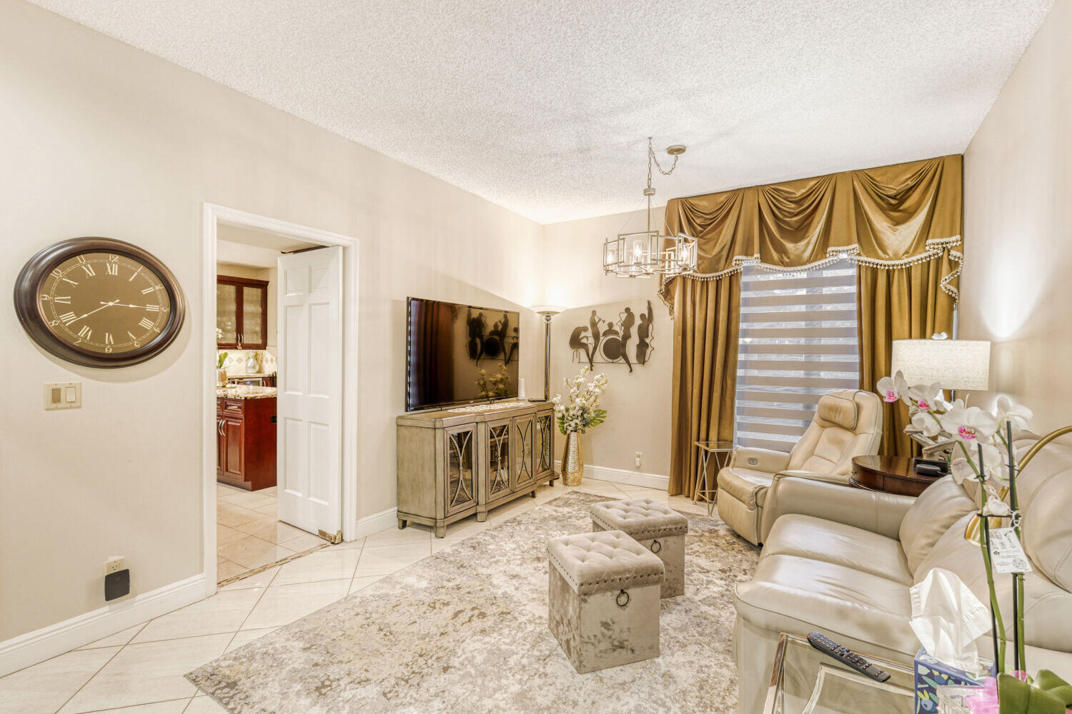 10273 St Andrews Road Boynton Beach, FL 33436 - Photo 16 of 28 a living room with furniture a flat screen tv and a large window