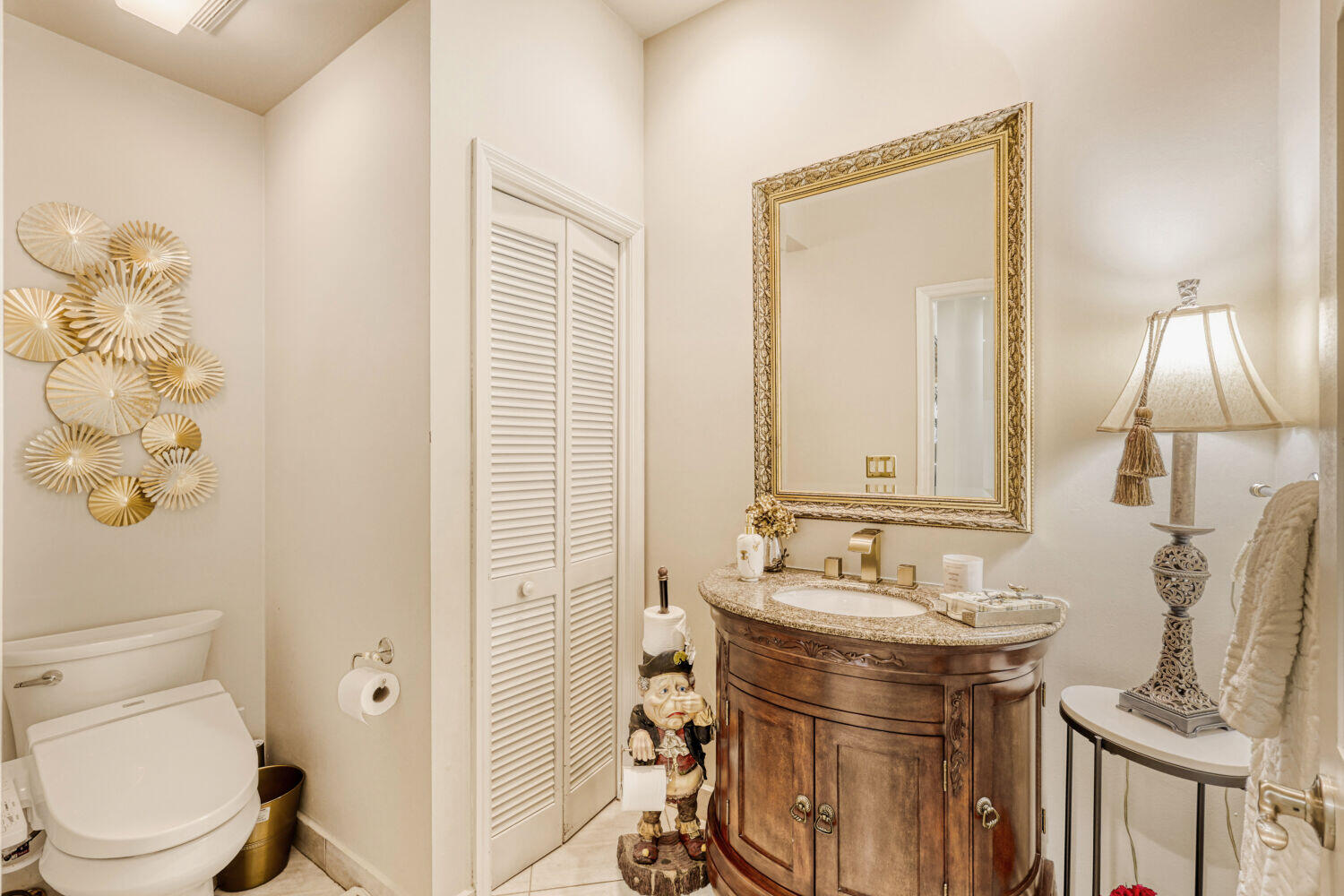 10273 St Andrews Road Boynton Beach, FL 33436 - Photo 18 of 28 a bathroom with a sink a toilet and mirror