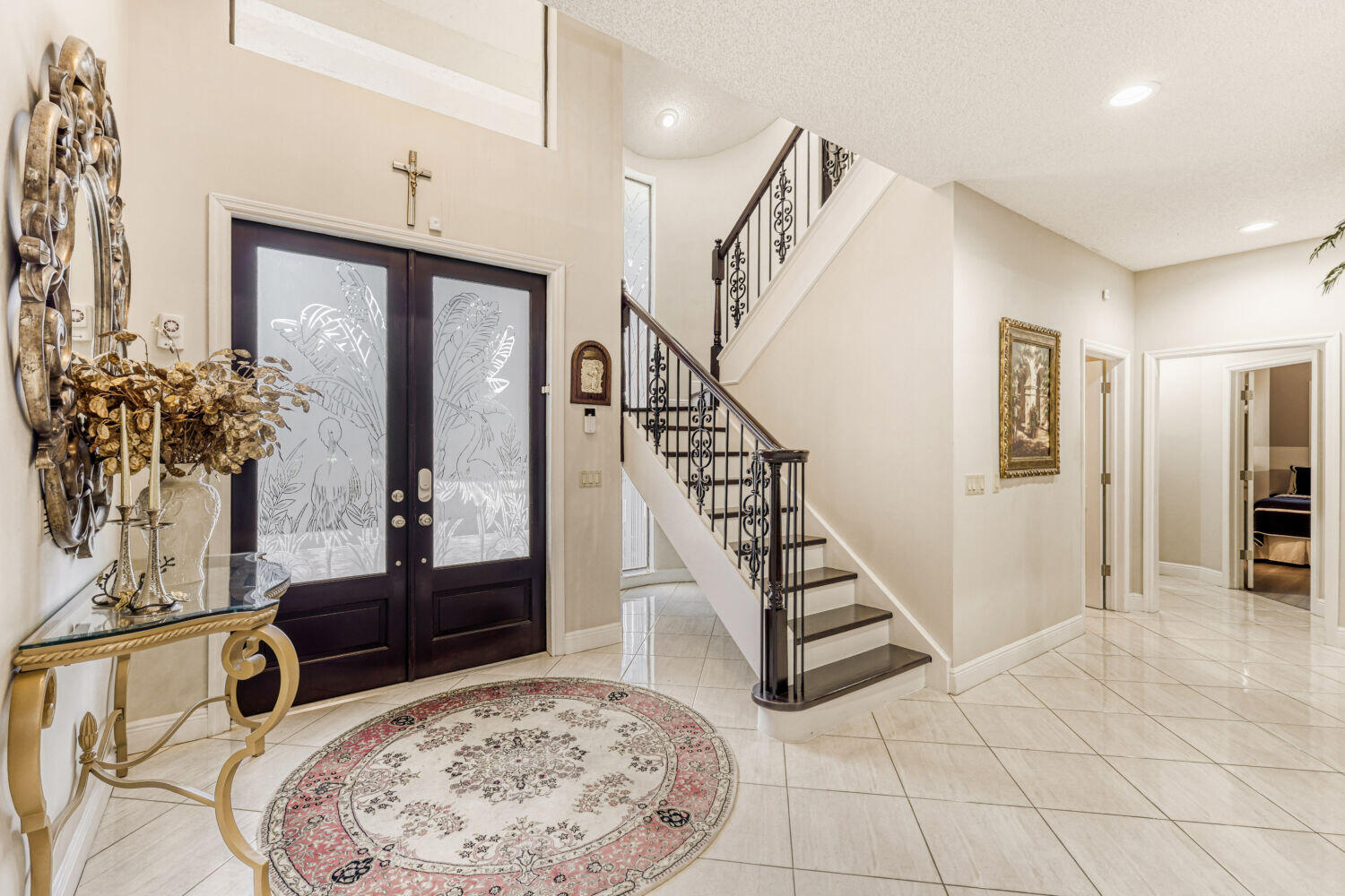 10273 St Andrews Road Boynton Beach, FL 33436 - Photo 4 of 28 a view of an entryway with wooden floor and a chandelier