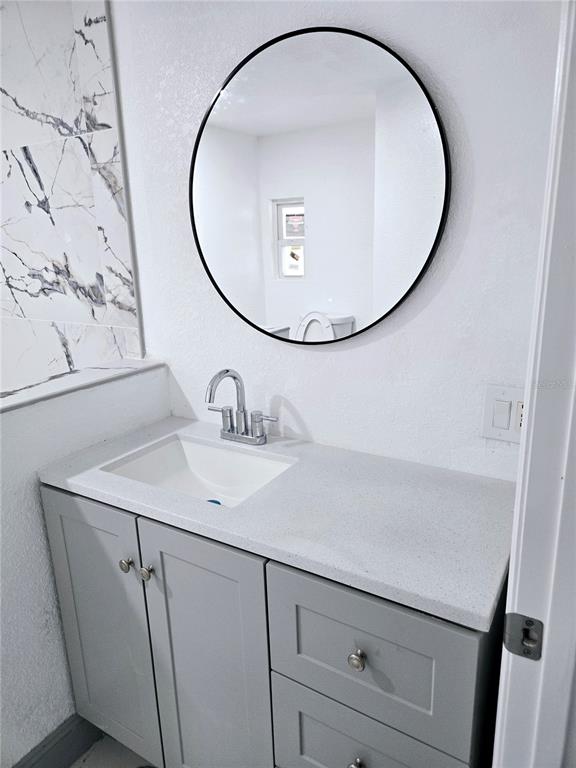 5860 Southwest 64th St Road Ocala, FL 34474 - Photo 5 of 11 a bathroom with a sink and a mirror