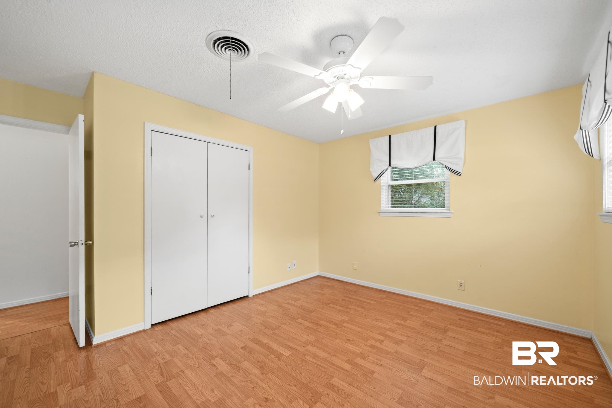 280 Thrift Street Mobile, AL 36609 - Photo 12 of 22 Unfurnished bedroom with light wood-type flooring, ceiling fan, and a closet