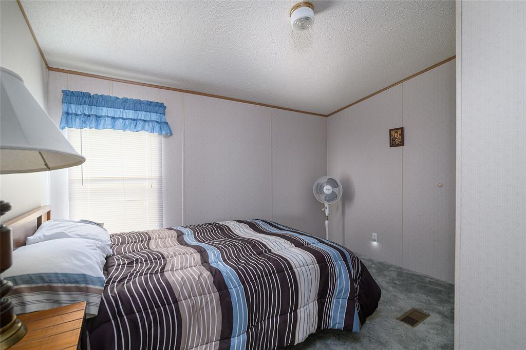 122 Grice Road Ringgold, LA 71068 - Photo 17 of 26 Bedroom featuring carpet flooring, paneled walls with wood trim, and a window with horizontal blinds