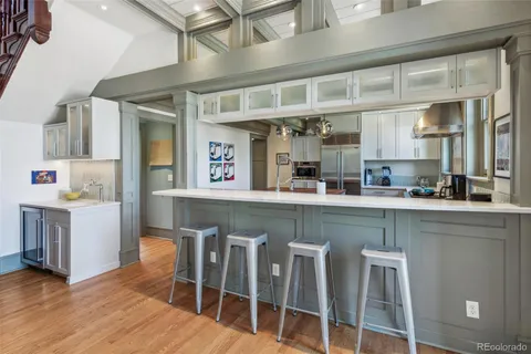 a kitchen with table chairs cabinets and stainless steel appliances