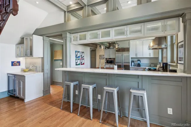 a kitchen with table chairs cabinets and stainless steel appliances