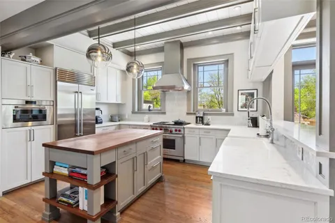 a kitchen with a stove a sink dishwasher and a refrigerator