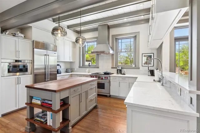 a kitchen with a stove a sink dishwasher and a refrigerator
