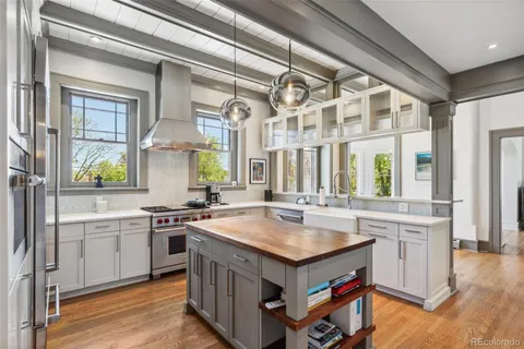 a kitchen with a sink stove and cabinets