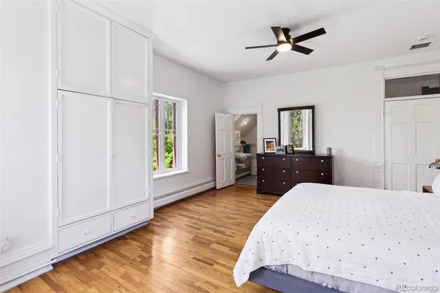 a living room with a bed furniture and a window