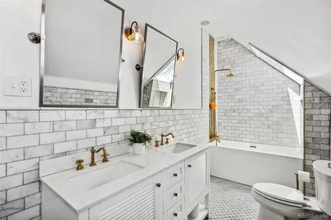 a bathroom with a sink toilet a mirror and shower