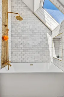 a bathroom with a bathtub and a shower