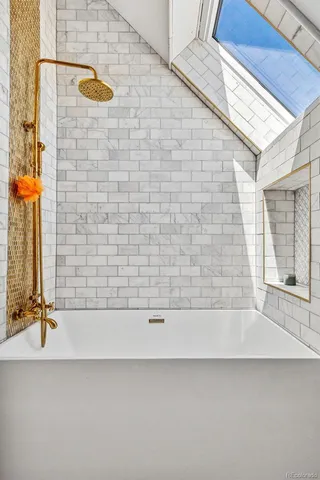 a bathroom with a bathtub and a shower