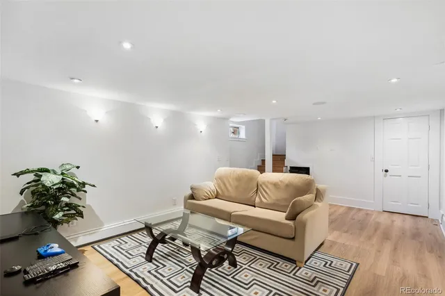 a living room with furniture and a potted plant