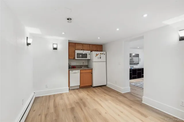 a kitchen with stainless steel appliances a refrigerator and a stove top oven