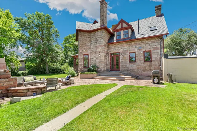 a view of a house with a yard and sitting area