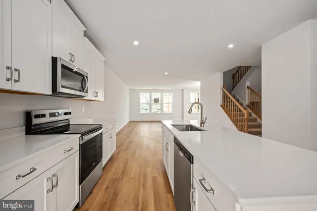 a kitchen with stainless steel appliances a refrigerator stove and microwave