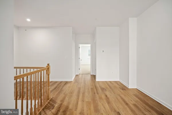 a view of a room with wooden floor and staircase