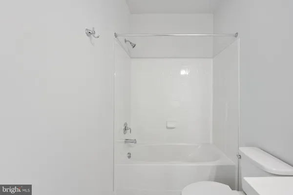 a bathroom with a sink vanity and toilet