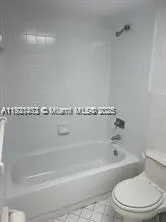 a bathroom with a bathtub and toilet