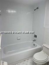 500 Executive Center Drive, Unit 1C West Palm Beach, FL 33401 - Photo 11 of 12 a bathroom with a bathtub and toilet