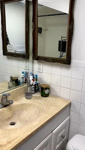 a bathroom with a sink a mirror and vanity