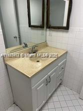 500 Executive Center Drive, Unit 1C West Palm Beach, FL 33401 - Photo 10 of 12 a bathroom with a sink and a mirror