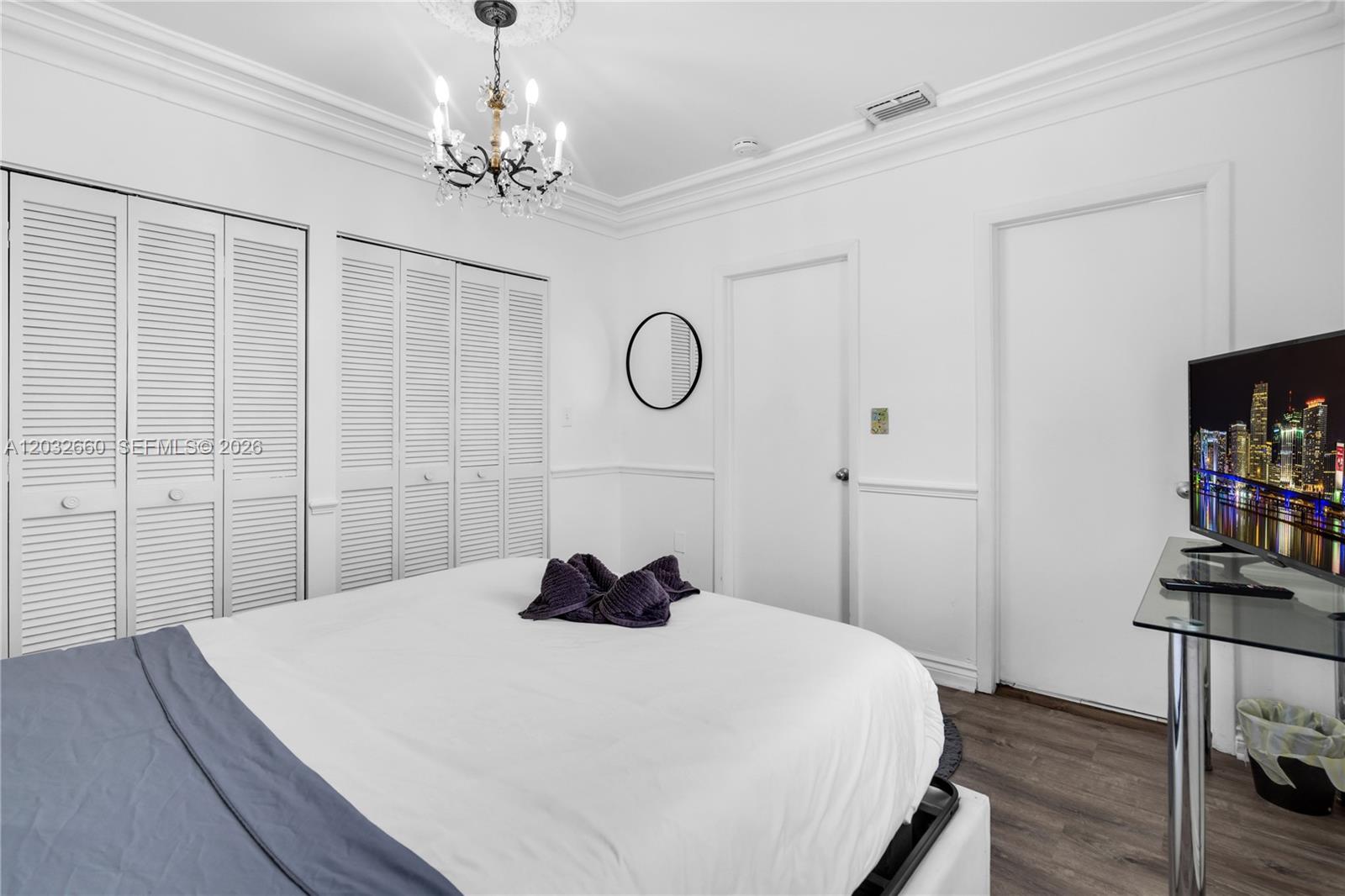 520 Southwest 22nd Road Miami, FL 33129 - Photo 56 of 76 a bedroom with a bed and a flat tv screen on the dresser